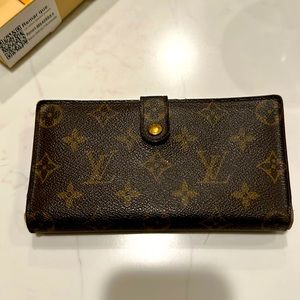 Louis Vuitton- Wallet. 7” long by 3.5” wide